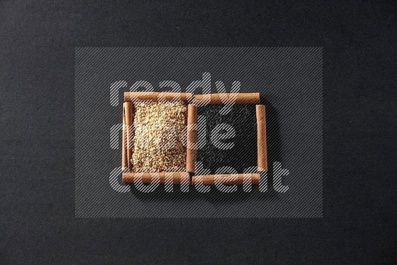 2 squares of cinnamon sticks full of sesame and black seeds on black flooring