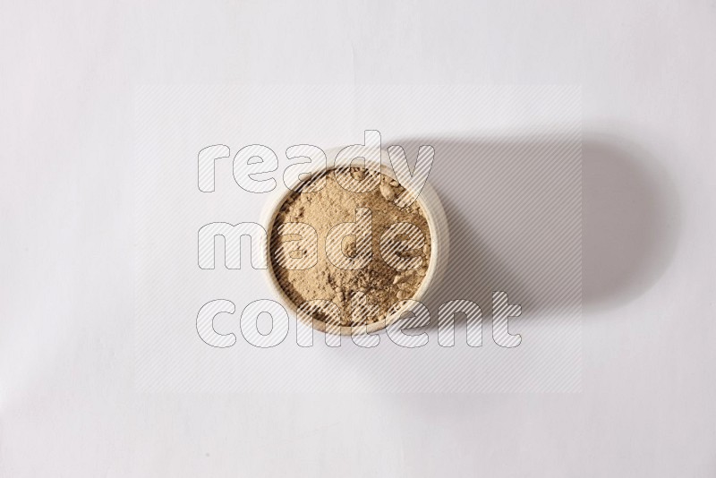 A beige pottery bowl full of garlic powder on a white flooring in different angles