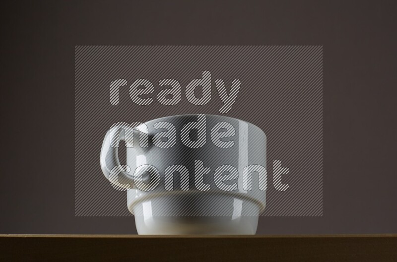 Low angle shot of a white cup on grey background