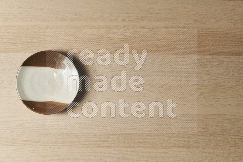 Top View Shot Of A Multicolored Pottery Plate on Oak Wooden Flooring