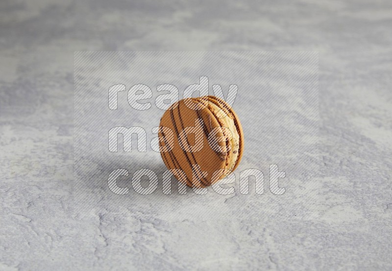 45º Shot of light brown  Almond Cream macaron on white  marble background