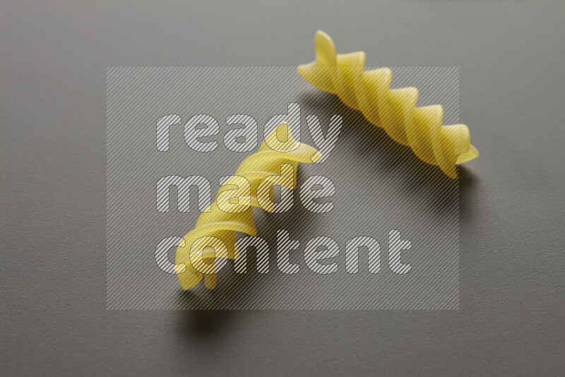 Fusilli pasta on grey background