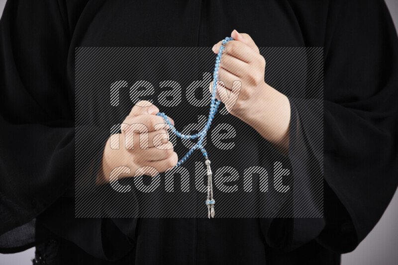 Woman hands holding praying beads (sebha) in different positions