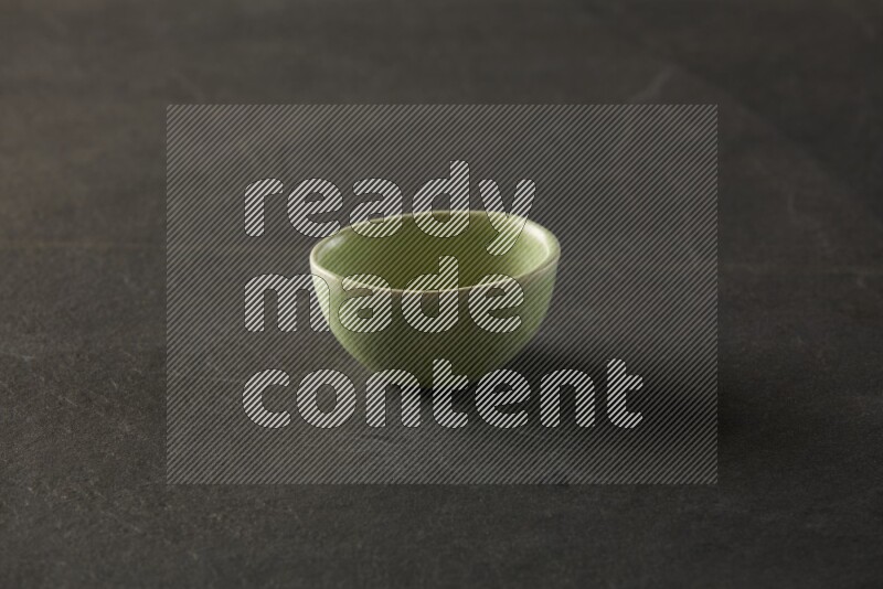 multi color round sauce bowl on grey textured countertop