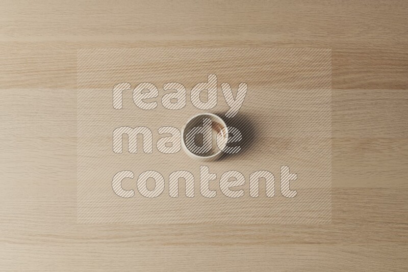 وعاء فخاري متعدد الألوان على خلفية خشبية فاتحة