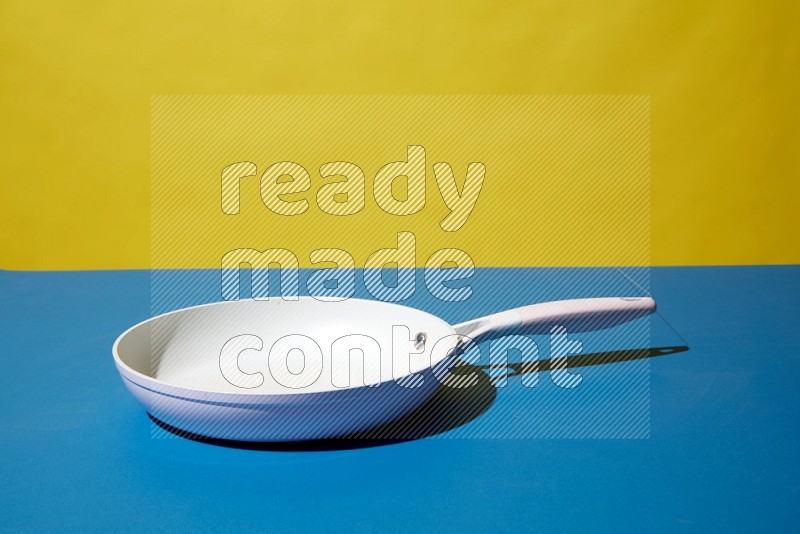 white pan on yellow and Blue background