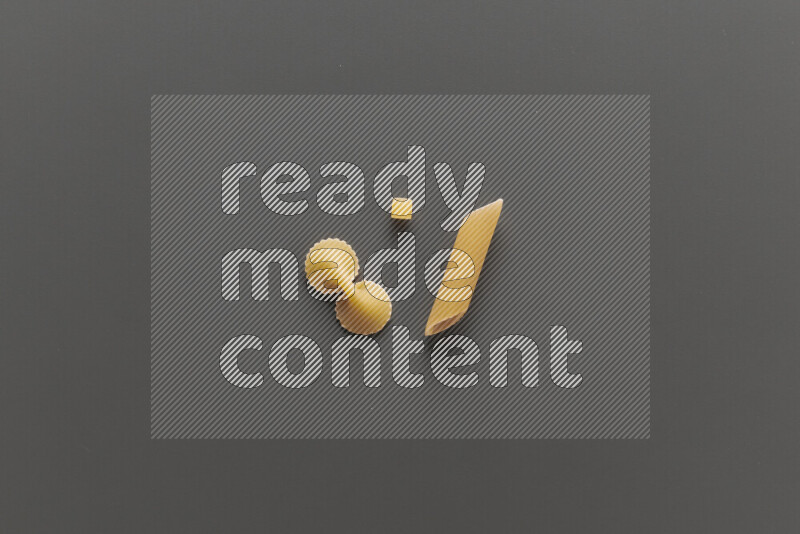 Different pasta types on grey background