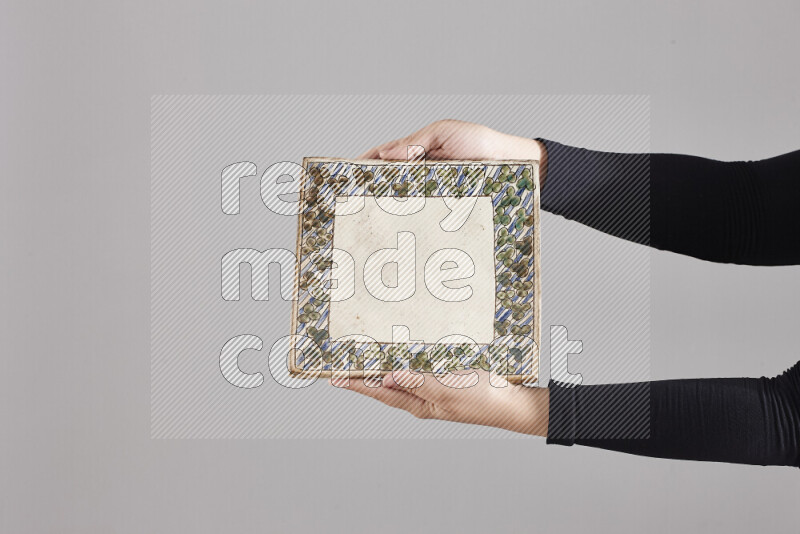 A woman in black abaya holding different pottery essentials in different positions