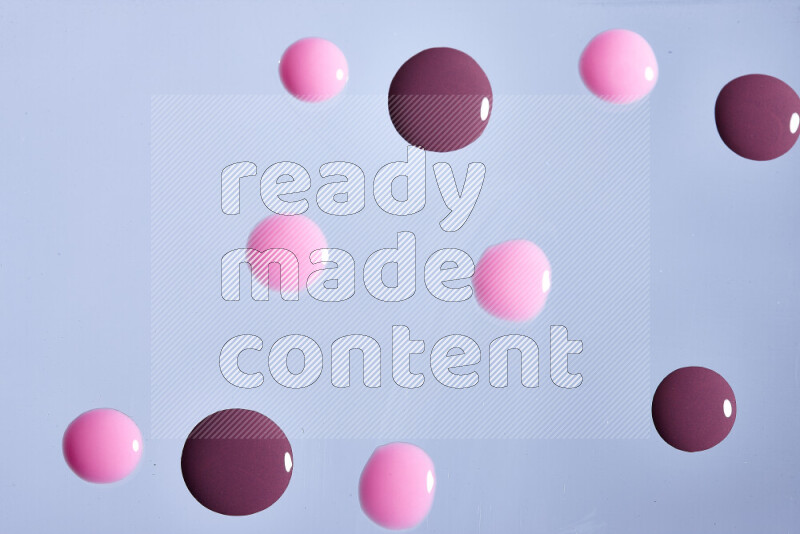 Close-ups of abstract purple and pink paint droplets on the surface