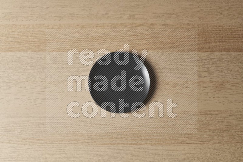 Top View Shot Of A Black Ceramic Circular Plate on Oak Wooden Flooring