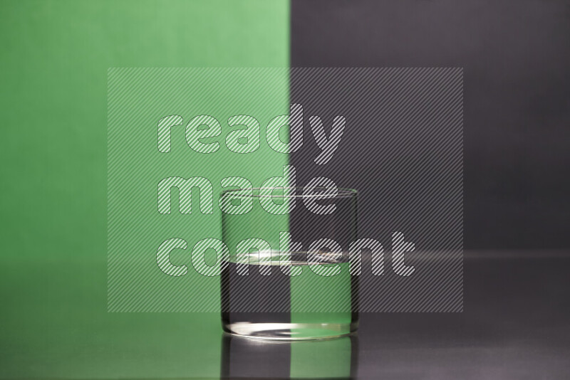 The image features a clear glassware filled with water, set against green and black background