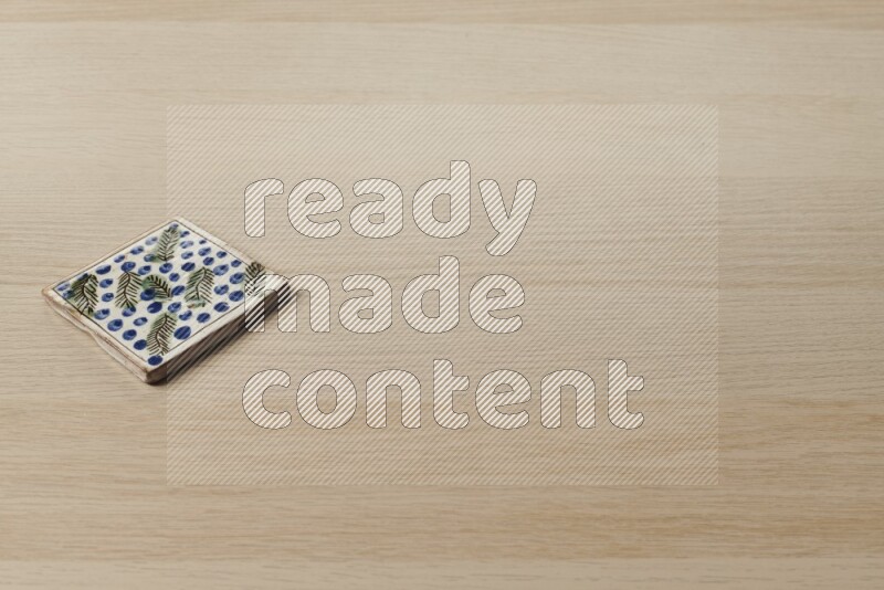 A decorative coaster on light wooden background