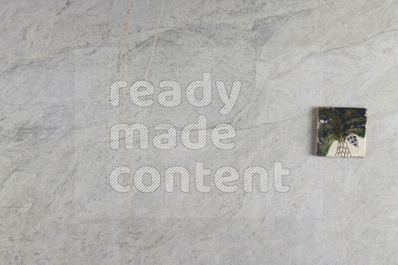 A decorative pottery coaster on grey marble background