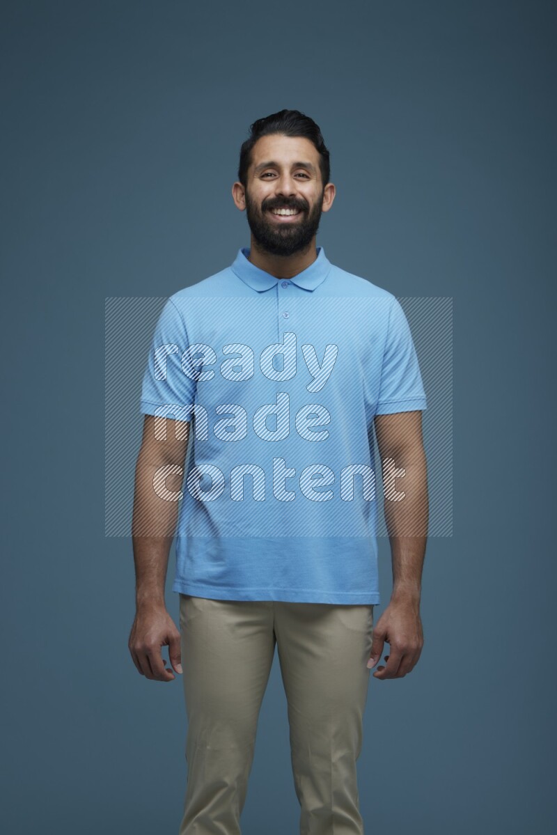 Man posing in a blue background wearing a Blue shirt
