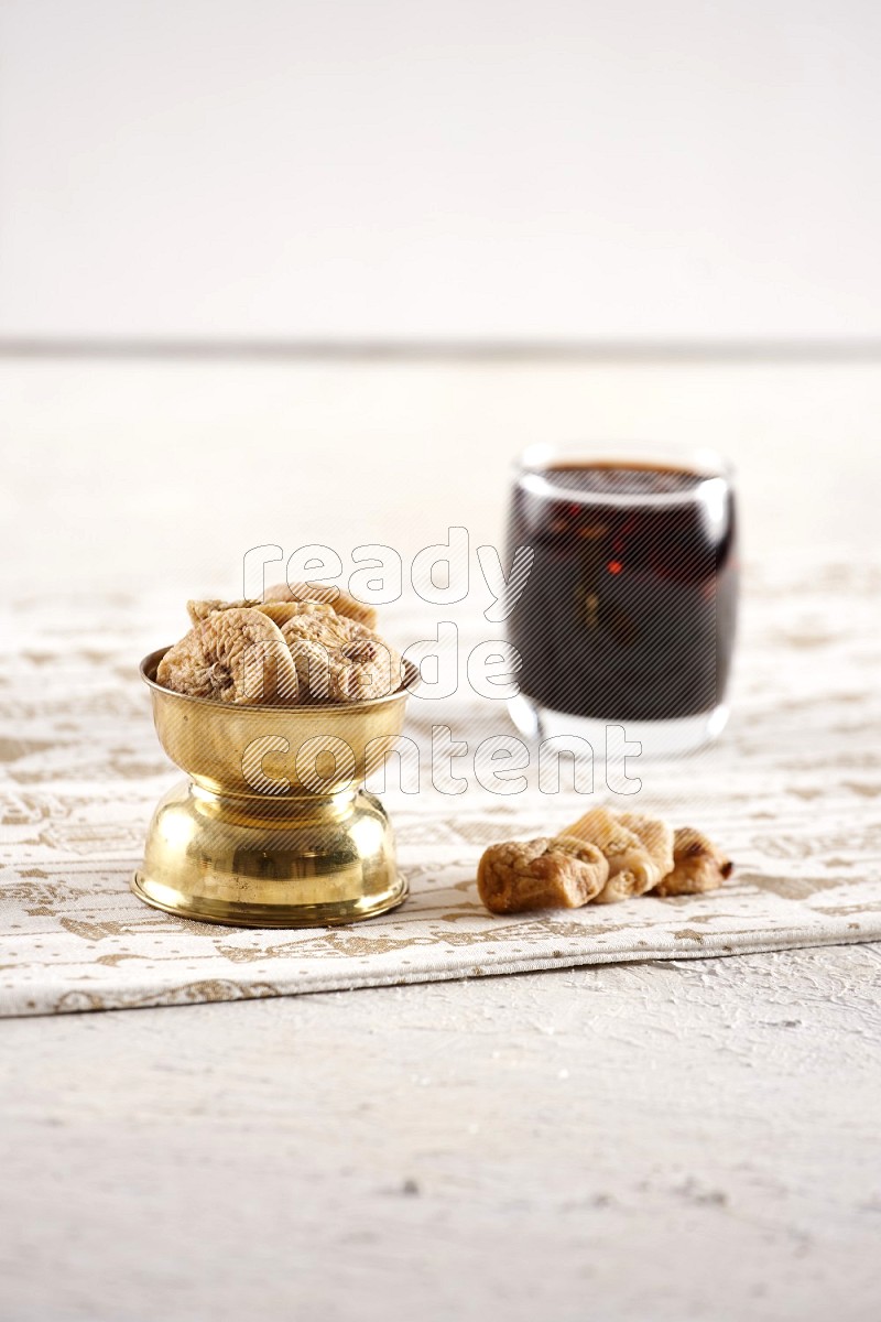Dried fruits in a metal bowl with tamarind in a light setup