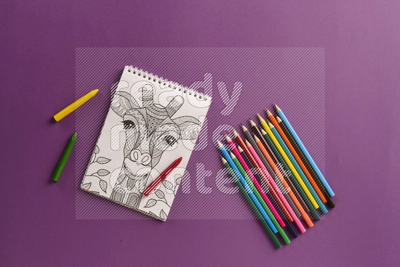 A coloring book with color pens on purple background (Back to school)