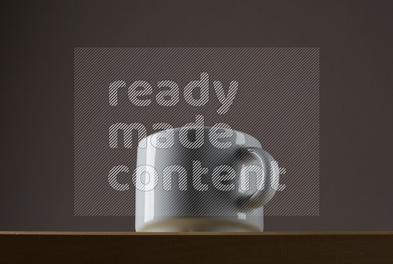 Low angle shot of a white cup on grey background