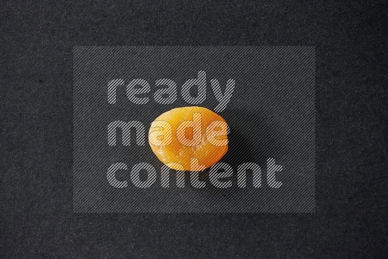 A dried apricot on a black background in different angles