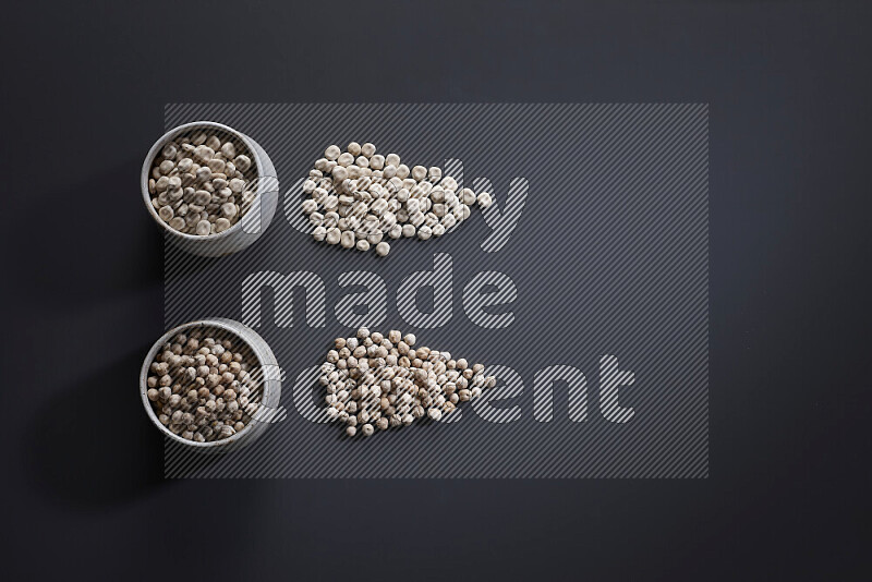 Legumes in pottery bowls on grey background