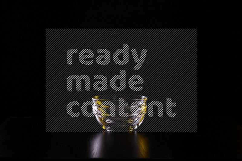 Glassware with rim light in yellow and white against black background