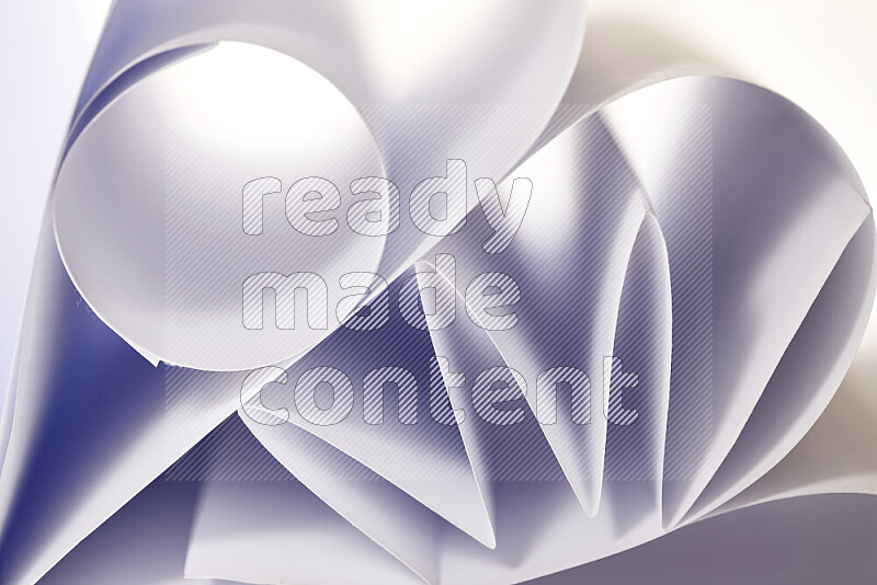 An artistic display of paper folds creating a harmonious blend of geometric shapes, highlighted by soft lighting in grey