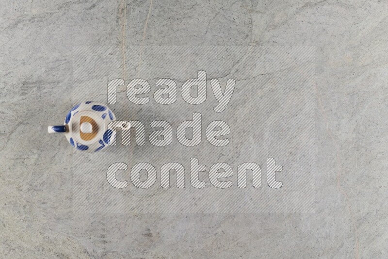 A pottery teapot on grey marble background