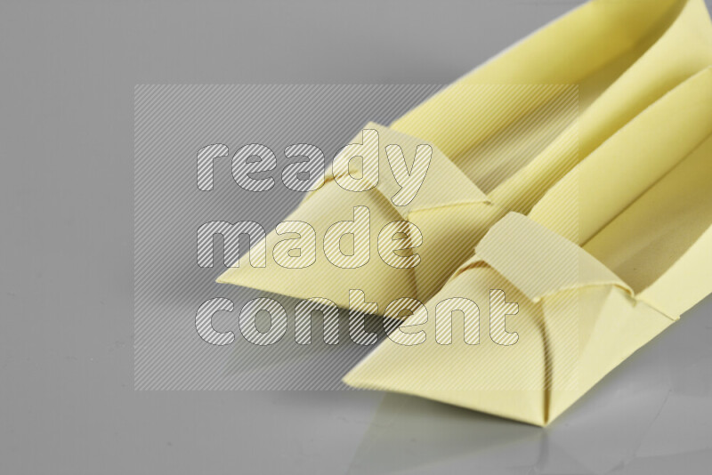 Origami shoes on grey background
