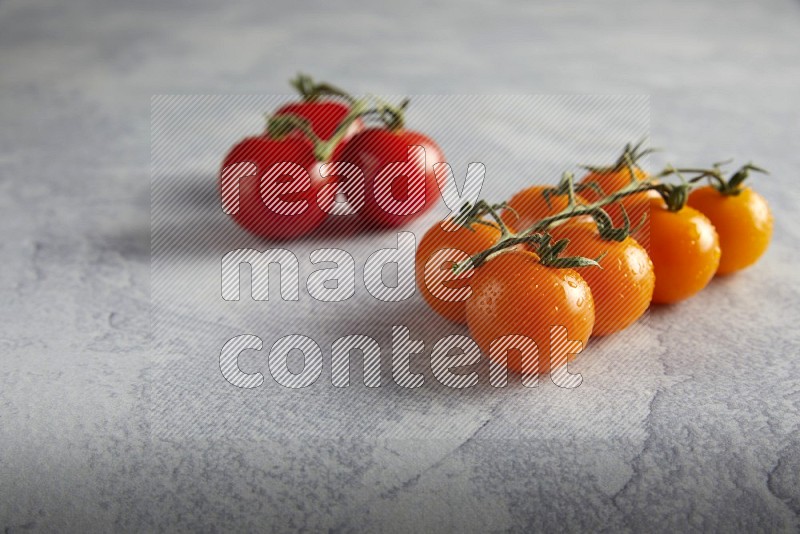 Mixed cherry tomato veins on a textured light grey background 45 degree