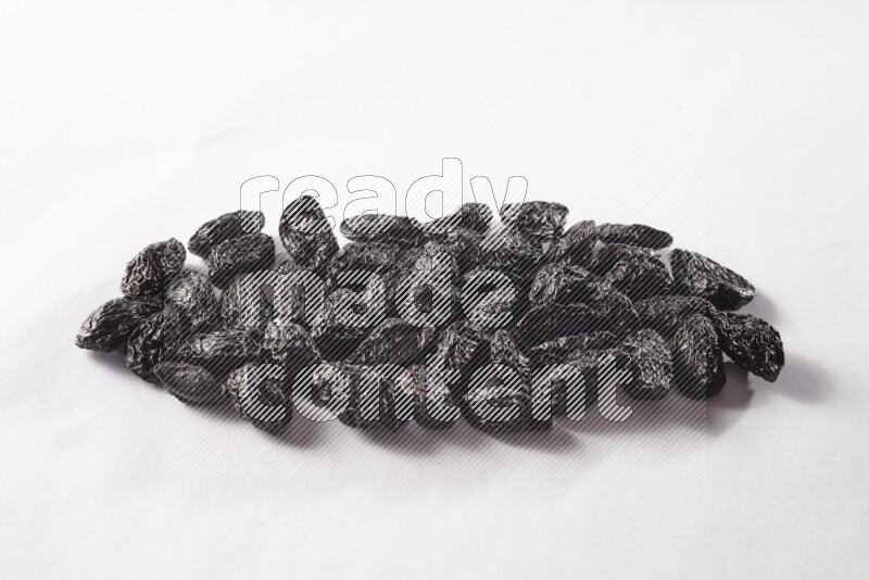 Dried plums on white background