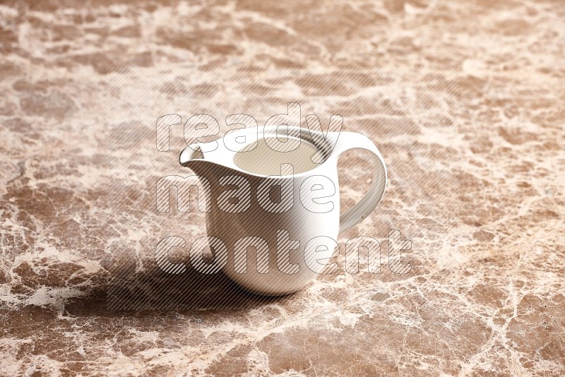 Ceramic Milk Jug on Beige Marble Flooring, 45 degrees