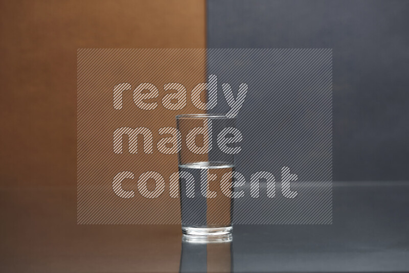 The image features a clear glassware filled with water, set against brown and dark blue background