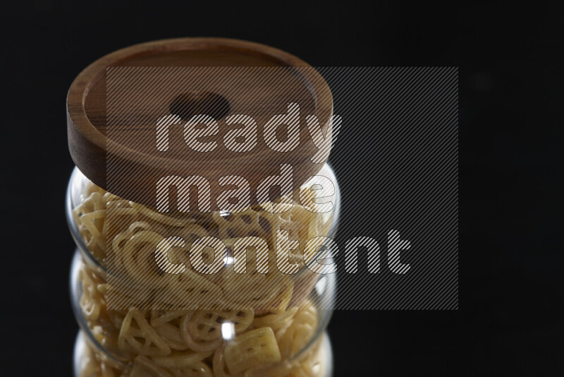 Snacks in a glass jar on black background