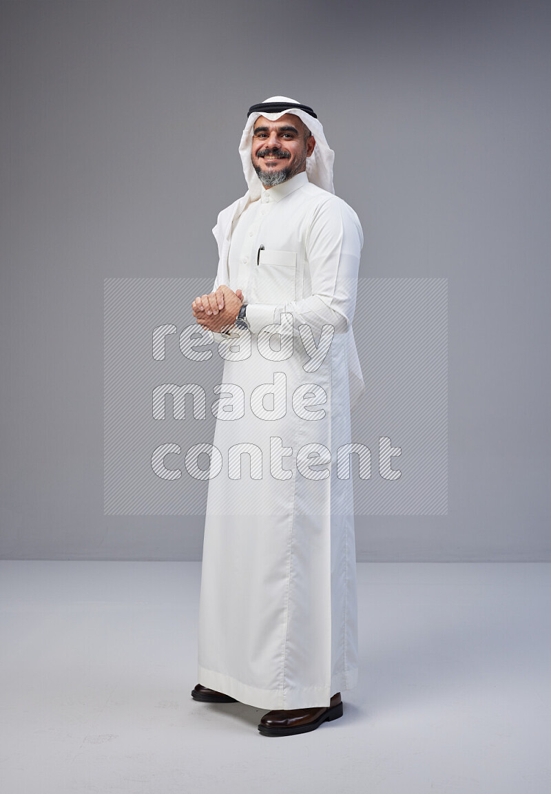 رجل سعودي يرتدي ثوب وشماغ ابيض يتفاعل امام الكاميرا