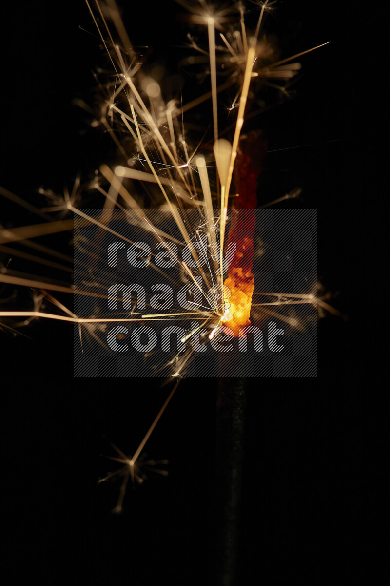 A close-up image of sparkler candle isolated on black background