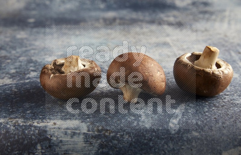 45 degre cremini  mushrooms on a textured rustic blue background