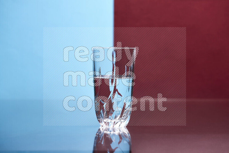 The image features a clear glassware filled with water, set against light blue and dark red background