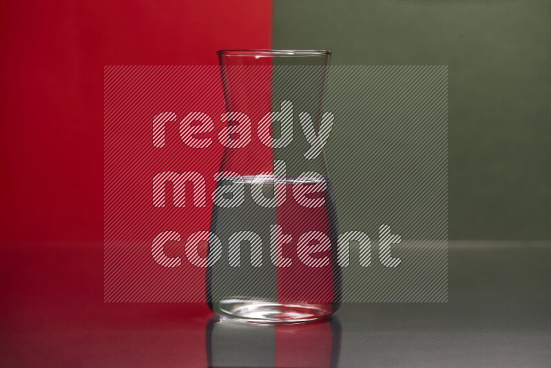 The image features a clear glassware filled with water, set against red and dark green background