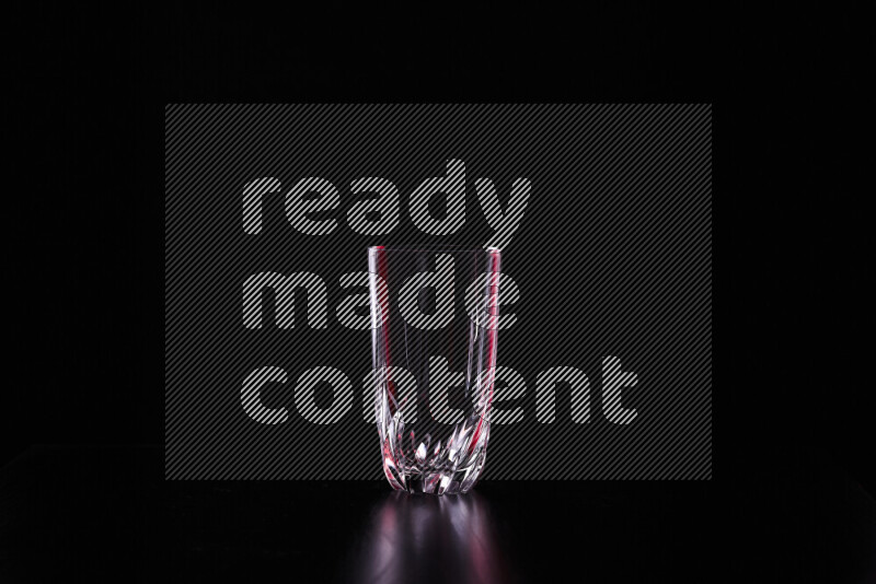 Glassware with rim light in red and white against black background