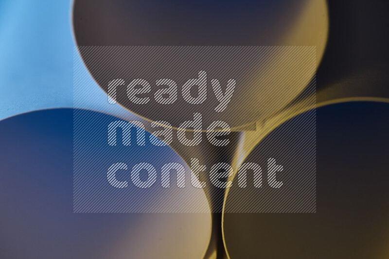 The image shows an abstract paper art with circular shapes in varying shades of blue and warm tones