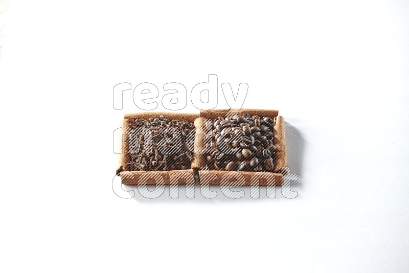 2 squares of cinnamon sticks full of coffee beans and cloves on white flooring