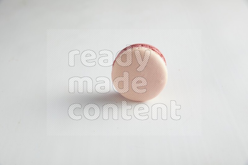 45º Shot of Pink Litchi Raspberry macaron on white background