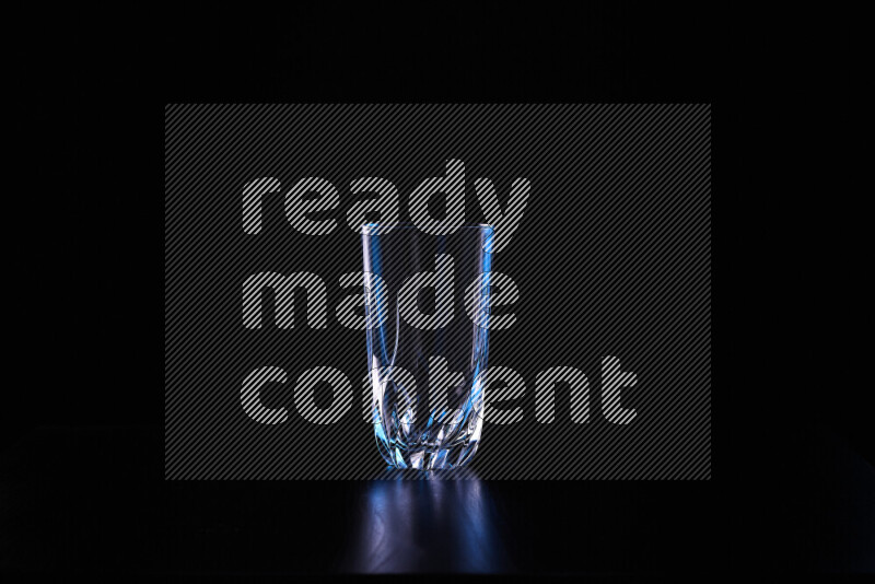 Glassware with rim light in blue and white against black background