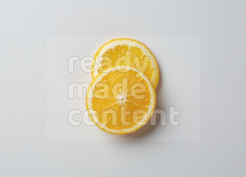 Two orange slices on white background