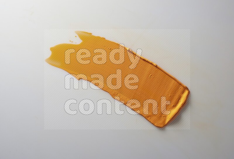 An orange straight painting knife stroke on white background