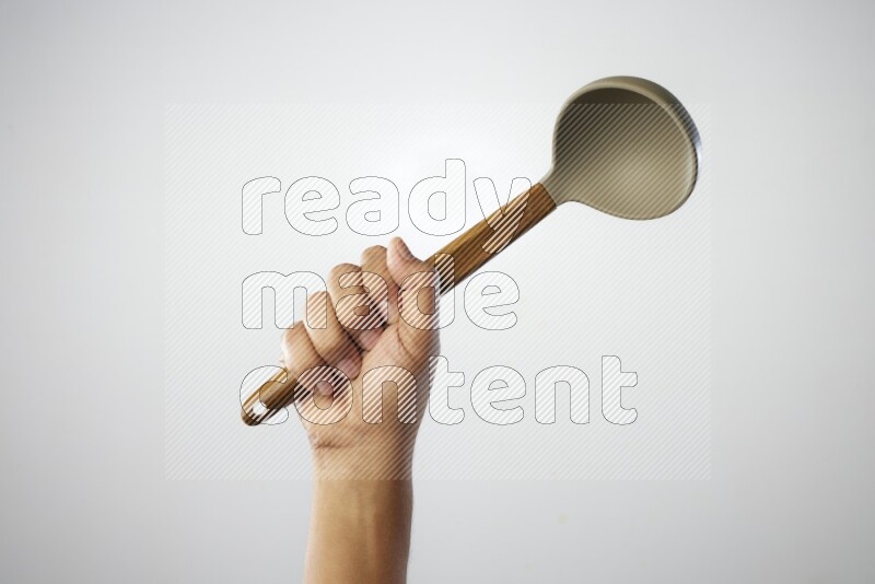 Male Hand Holding ladle on white background
