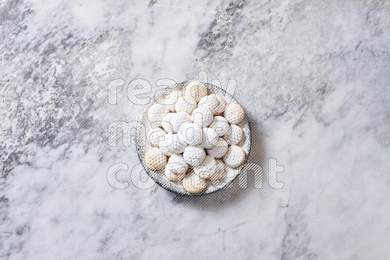 Kahk in black pottery plate on grey marble background