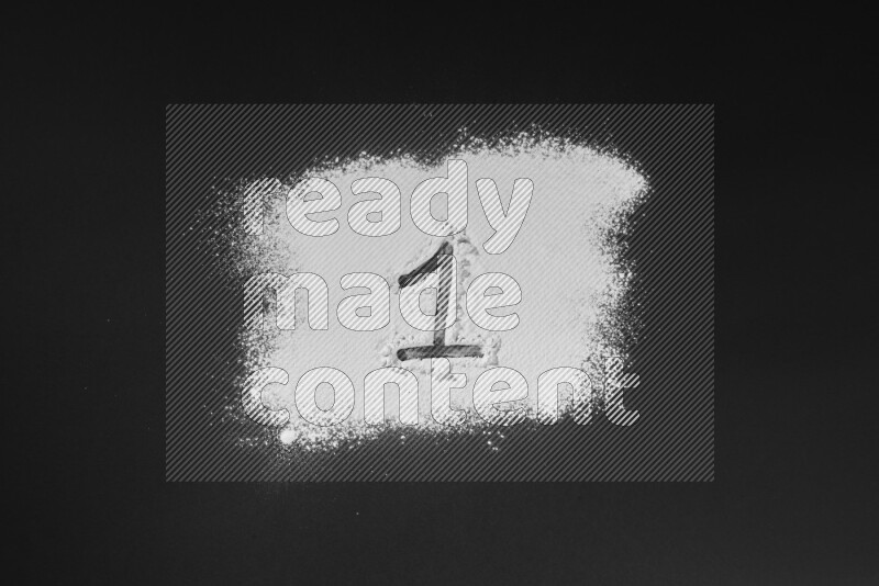 Numbers written with powder on black background