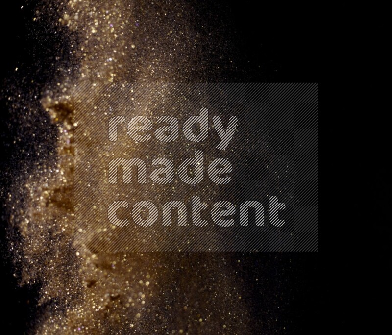 Gold glitter powder isolated on black background