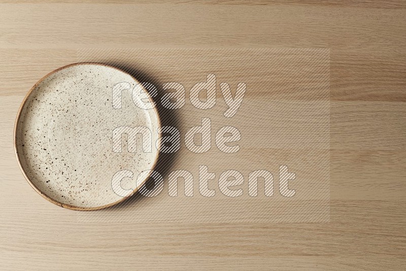 Top View Shot Of A Multicolored Pottery Plate on Oak Wooden Flooring