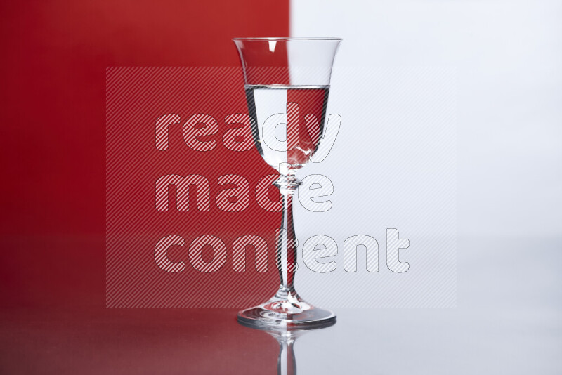 The image features a clear glassware filled with water, set against white and red background